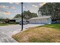View of three garages and a parked car in front of a house at 3122 37Th S Ln # C, St Petersburg, FL 33711