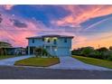 Beautiful two-story home with metal roof, well-manicured lawn, and charming curb appeal at 3174 Sanibel Dr, Hernando Beach, FL 34607
