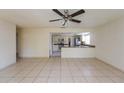 Bright living room showcasing tile flooring and a glimpse of the eat-in kitchen at 3719 Greenford St, Valrico, FL 33596