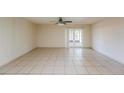 Open living area features neutral tile flooring and access to the outdoor patio at 3719 Greenford St, Valrico, FL 33596