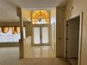 Bright foyer featuring tile flooring, a decorative chandelier, and a view into the living space at 4593 Goldcoast Ave, Spring Hill, FL 34609