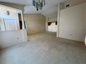 Spacious living room with neutral carpet, high ceilings, and lots of natural light at 4593 Goldcoast Ave, Spring Hill, FL 34609
