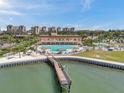 A pier leads to a swimming pool at a tropical resort destination at 4900 Brittany S Dr # 805, St Petersburg, FL 33715
