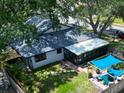 Aerial shot of a well-maintained property featuring a backyard patio and screened in porch at 5021 Roanoke Dr, Holiday, FL 34690