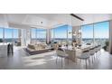 Bright, modern living area with floor-to-ceiling windows offering panoramic city views, stylish furniture, and contemporary design at 520 N Tampa St # 4201, Tampa, FL 33602