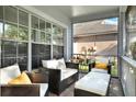 Inviting screened porch with comfortable seating, perfect for relaxation and enjoying the outdoors at 6526 Summer Cove Dr, Riverview, FL 33578