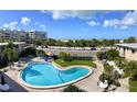 Elevated view of an outdoor community pool with beach views across the street at 6700 Sunset Way # 206, St Pete Beach, FL 33706