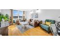 Bright living room with hardwood floors, modern decor and natural light, perfect for relaxing and entertaining at 701 S Madison Ave # 414, Clearwater, FL 33756