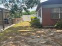 View of a spacious backyard with a chain-link fence and a white privacy fence at 7401 N Albany Ave, Tampa, FL 33604