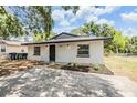 Updated home with new landscaping, gray roof and painted driveway at 8107 N 11Th St, Tampa, FL 33604