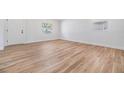 Light and airy living room with white walls and wood-look flooring at 8107 N 11Th St, Tampa, FL 33604