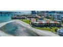 Aerial view showcasing condos on a waterfront property with bridge access and beautiful beach at 865 S Gulfview Blvd # 308, Clearwater, FL 33767
