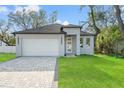 Charming single-Gathering home with a well-manicured lawn and a paved driveway at 8906 N Otis Ave, Tampa, FL 33604