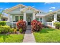 Inviting home exterior featuring a well-manicured lawn, colorful foliage, and a welcoming front entrance at 9503 W. Park Village Dr, Tampa, FL 33626