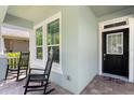 Cozy porch with rocking chairs, offering a relaxing outdoor space with a view of the neighborhood at 9503 W. Park Village Dr, Tampa, FL 33626