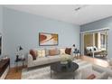 Comfortable living room with neutral tones, featuring a plush sofa, coffee table, and sliding glass doors to the patio at 1051 Andrew Aviles Cir, Tampa, FL 33619