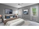 Tranquil main bedroom with large windows, soft carpet, and elegant decor, creating a serene retreat at 1051 Andrew Aviles Cir, Tampa, FL 33619
