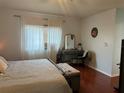 Comfortable bedroom featuring a large window and a dedicated vanity area with a decorative mirror at 11227 Summer Star Dr, Riverview, FL 33579