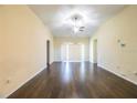 Bright living room with hardwood floors, a ceiling fan, and sliding glass doors at 16616 Magnolia Reserve Pl, Wimauma, FL 33598