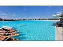 A resort-style pool with clear turquoise water and multiple kayaks on the shore at 16815 Trite Bend St, Wimauma, FL 33598