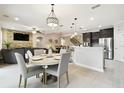 Open-concept living space features a dining area, kitchen with stainless steel, and a cozy living room at 1796 Tonka Ter, Wesley Chapel, FL 33543