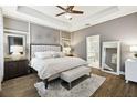Serene main bedroom boasts a tray ceiling, plush carpeting, and a luxurious ensuite bathroom at 1796 Tonka Ter, Wesley Chapel, FL 33543