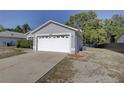 View of the two-car garage and the side of the charming single-story home at 18918 Emerald Ridge Dr, Hudson, FL 34667