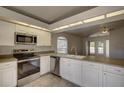 Bright kitchen featuring stainless steel appliances and plenty of cabinet space at 18918 Emerald Ridge Dr, Hudson, FL 34667