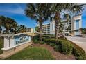 Community signage showing the name Dolphin Key Condominiums in front of lush landscaping at 19519 Gulf Blvd # 203, Indian Shores, FL 33785
