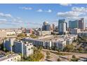 An aerial view showcasing an urban condo complex with contemporary design and city skyline backdrop at 201 W Laurel St # 704, Tampa, FL 33602