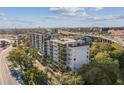 A modern condo complex overlooks lush trees and the freeway in this sun-drenched exterior shot at 201 W Laurel St # 704, Tampa, FL 33602