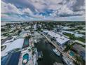 Expansive aerial view showcases the neighborhood, canals, and waterfront homes at 2186 Edythe Dr # 11, Dunedin, FL 34698