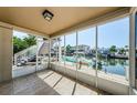 Screened lanai with tile flooring and boat dock view, perfect for enjoying waterfront living at 2186 Edythe Dr # 11, Dunedin, FL 34698