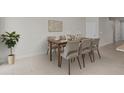 Bright dining room featuring a wooden table with seating for six, perfect for Gathering meals and entertaining guests at 2432 Hearth Dr, Odessa, FL 33556