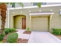 Charming townhome showcasing a single-car garage, covered entryway, and well-maintained landscaping at 2746 Birchcreek Dr, Wesley Chapel, FL 33544