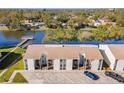 An aerial view of a condo building overlooking a serene lake, showcasing picturesque waterfront community at 3823 N Oak Dr # K22, Tampa, FL 33611