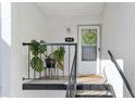Charming condo entrance with a monstera plant and decorative wreath, showcasing a welcoming exterior at 3823 N Oak Dr # K22, Tampa, FL 33611