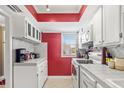 Bright, galley-style kitchen features white appliances, ample counter space, and a window for natural light at 3823 N Oak Dr # K22, Tampa, FL 33611