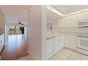 Bright kitchen featuring white cabinets and appliances overlooking the living area at 402 Laurel Lake Dr # 104, Venice, FL 34292