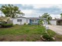 Charming single-story home with stone facade, lush lawn and well-manicured landscaping with a mailbox at 4545 Annette St, New Port Richey, FL 34652