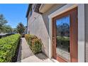 Inviting front door featuring a decorative glass door and well-maintained landscaping at 5005 Blue Latan Ln, Tampa, FL 33610