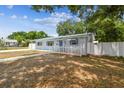Charming home featuring a bright white picket fence enhancing curb appeal at 504 E Lee St, Plant City, FL 33563