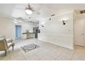 Open living room featuring neutral tile flooring and ceiling fans for comfort at 504 E Lee St, Plant City, FL 33563