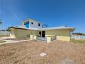 Charming two-story home with a quaint front porch, a unique exterior, and a well-kept lawn at 5930 Bahama N Way, St Pete Beach, FL 33706