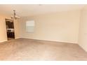 A spacious living room with neutral carpet and plenty of light at 621 Washita Stone Dr, Ruskin, FL 33570