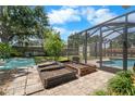 Backyard featuring a brick-paved area, raised garden beds, screened in pool area and a shed at 6307 S Cameron Ave, Tampa, FL 33616