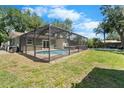 Screened in pool area and spacious backyard, perfect for relaxation and entertainment at 6307 S Cameron Ave, Tampa, FL 33616