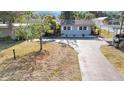 A beautiful single-story home with an attached garage, updated exterior, and well manicured lawn at 6811 N Himes Ave, Tampa, FL 33614