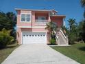 Inviting two-story home featuring a two-car garage, landscaped yard, and concrete driveway at 6926 Mccray Dr, Hudson, FL 34667