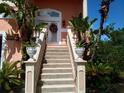 Grand entrance with decorative stairs, flower boxes, and double doors with a wreath at 6926 Mccray Dr, Hudson, FL 34667